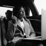 Grayscale Photo Of Woman Sitting Inside A Car