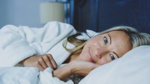 woman smiling in bed