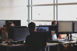 People sitting at desks in an office, working quietly.
